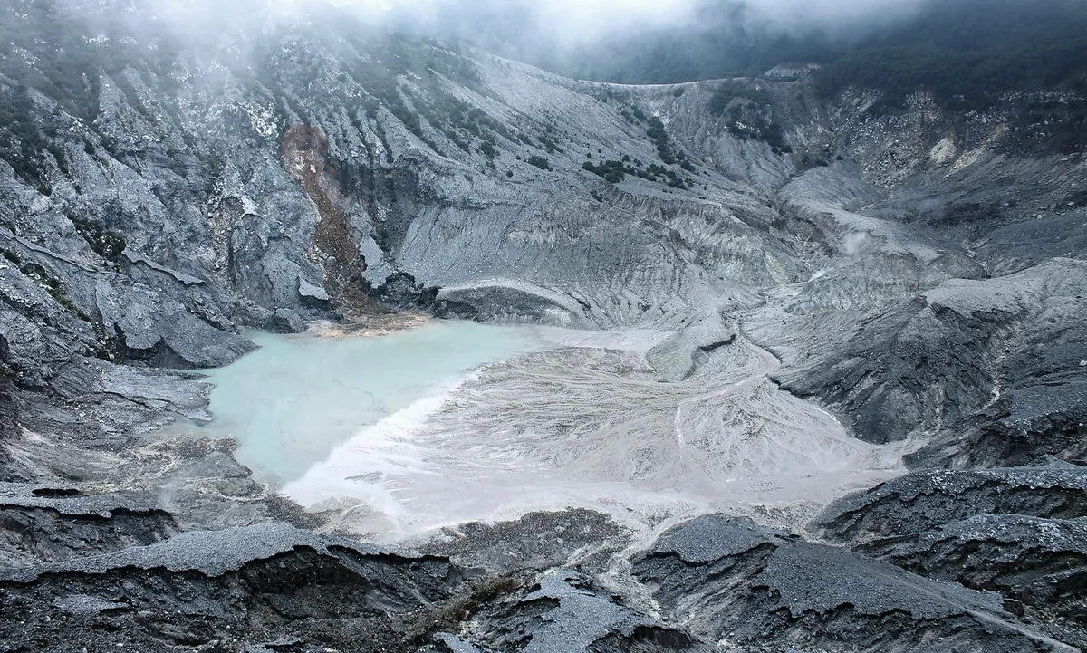 Kelimutu volcano with three differently-colored crater lakes at sunrise, central Flores